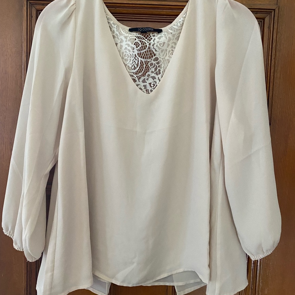 Flowy beige top with lacy exposed back and v-neck. Great for work!